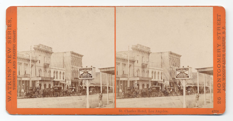 Shows the St. Charles Hotel in Los Angeles with carriages lined up out front.